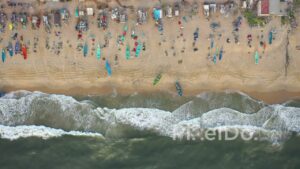PD0925 - Top-Down Aerial Pan of a Bustling Fishing Beach