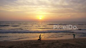PD0922 - Scenic Aerial View of People Enjoying a Beach Sunrise