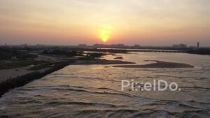 PD0905 - Panoramic Aerial Sunset over a Coastal City and Jetty