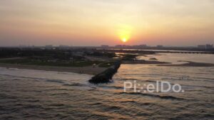 PD0904 - Stunning Aerial Pullback of a Jetty at Sunset