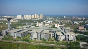 PD0955 - Aerial Pan of Modern Corporate Park with Coastal Cityscape