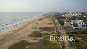 PD0946 - Drone Captures Morning Walkers Along a Scenic Seaside Promenade