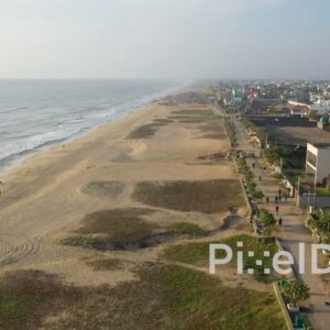 PD0946 - Drone Captures Morning Walkers Along a Scenic Seaside Promenade