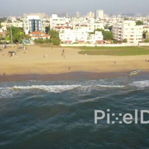 PD0943 - Drone Pans Across Urban Beach with Fishermen at Work