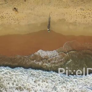 PD0940 - Top-Down Drone View of Couple Walking by the Ocean's Edge