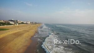 PD0939 - Drone Glides Along a Populated City Beach
