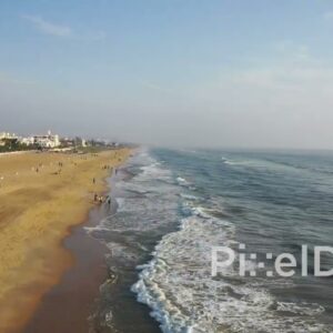 PD0939 - Drone Glides Along a Populated City Beach