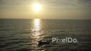 PD0935 - Drone View of a Lone Fishing Boat at Sunrise