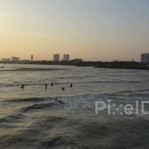 PD0979 - Aerial Drone Orbits Surfers at Golden Hour Sunset