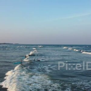 PD0977 - Aerial Drone View of a Surf Lesson in the Ocean