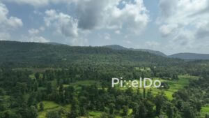 PD1038 - Aerial Drone Flight Over Green Valley, Fields, and Forested Mountains