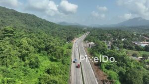PD1037 - Aerial Drone Flight Over Scenic Highway Through Mountain Valley