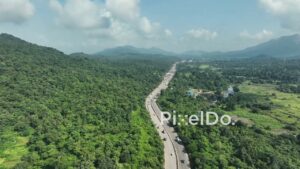 PD1033 - Scenic Aerial Drone Shot of Highway Winding Through Lush Green Mountains