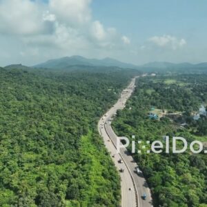 PD1033 - Scenic Aerial Drone Shot of Highway Winding Through Lush Green Mountains