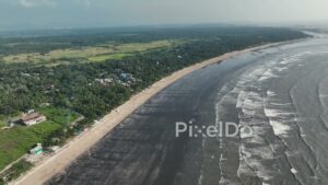 PD1078 - Aerial Drone Pan Over Tropical Coastline and Dark Sand Beach