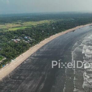 PD1078 - Aerial Drone Pan Over Tropical Coastline and Dark Sand Beach