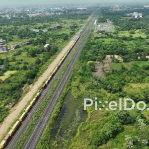 PD1061 - Aerial Drone Flight Over a Long Freight Train on a Suburban Corridor