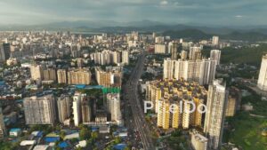 PD1105 - Aerial Drone Flight Over Dense Urban Cityscape with Highway and Metro
