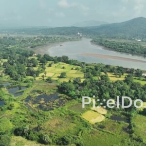 PD1021 - Aerial Flight Over Lush River Valley and Mountain Landscape