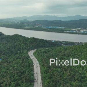 PD1094 - Aerial Drone Flight Over Scenic Highway, Forested Hill, and River