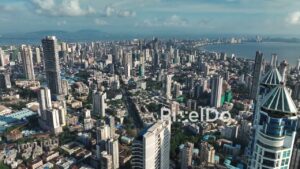 PD1143 - Aerial Drone Pan of Dense Cityscape and Curving Coastline