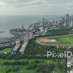 PD1121 - Aerial Drone Flight Over Coastal Interchange, Racecourse, and City Skyline
