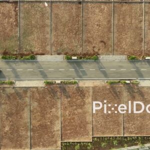 PD1161 - Top-Down Aerial Drone Tracking Red Car in New Land Plot Development