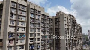 PD1151 - Aerial Drone Tilt-Up of Urban High-Rise Apartment and Adjacent Slum