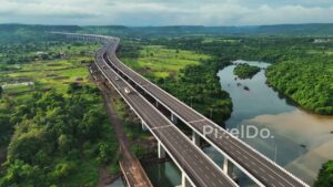 PD1191 - Aerial Drone Pullback of Expressway Viaduct Over River and Green Valley