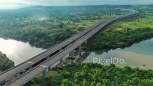 PD1190 - Aerial Drone Pan of Curving Expressway Viaduct in Scenic Green Valley