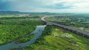 PD1188 - Aerial Drone Flight Over Scenic River and Curving Expressway Viaduct