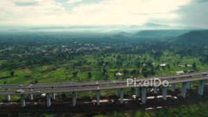 PD1185 - Aerial Drone Pan of Curving Expressway Viaduct in Green Valley