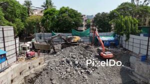 PD1006 - Excavator Loading Rocks and Rubble into a Dump Truck at Construction Site
