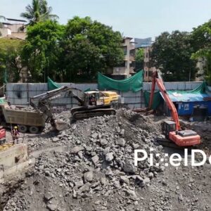 PD1006 - Excavator Loading Rocks and Rubble into a Dump Truck at Construction Site