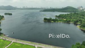 PD1004 - Aerial Pullback Shot of Vihar Lake, Mumbai, with Distant Urban Skyline