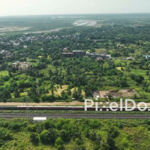 PD1060 - Aerial Drone Tracking Shot of a Train in a Suburban Landscape