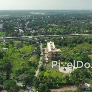 PD1054 - Aerial Drone Flight Following a Commuter Train Through Suburban Landscape