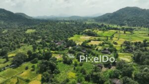 PD1048 - Aerial Drone Pan of Rural Valley with Village and Paddy Fields