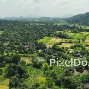 PD1048 - Aerial Drone Pan of Rural Valley with Village and Paddy Fields