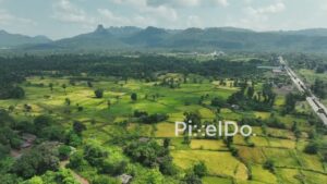 PD1045 - Aerial Drone Pan Over Rural Valley, Highway, and Mountains