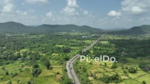 PD1044 - Aerial Drone View of Highway Winding Through Rural Mountain Valley