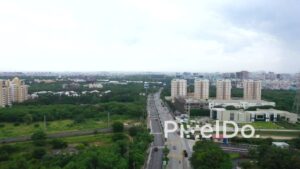 PD1345 - Aerial View of Urban Road Traffic and Residential Skyline