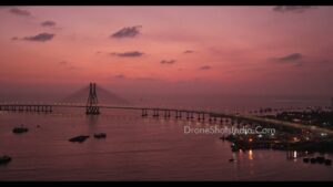 PD1206 - Aerial View of Illuminated Cable-Stayed Bridge Over Sea at Twilight