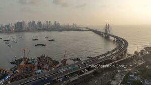 PD1253 - Aerial View of Bandra Worli Sea Link, Coastal Construction, and Skyline at Sunset