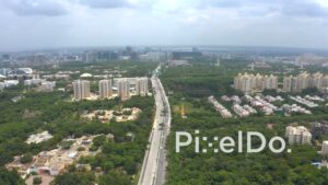 PD1286 - Aerial Wide View of Long Highway Leading to Modern City Skyline